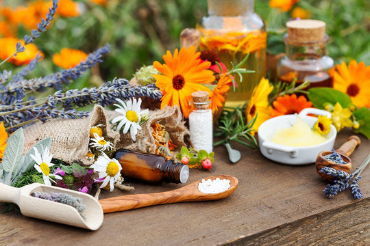 Various health supplement forms including tablets, capsules, and tincture bottles arranged on a clean surface