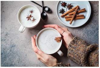 Warm wholesome winter drinks including turmeric latte and herbal tea on a cosy table