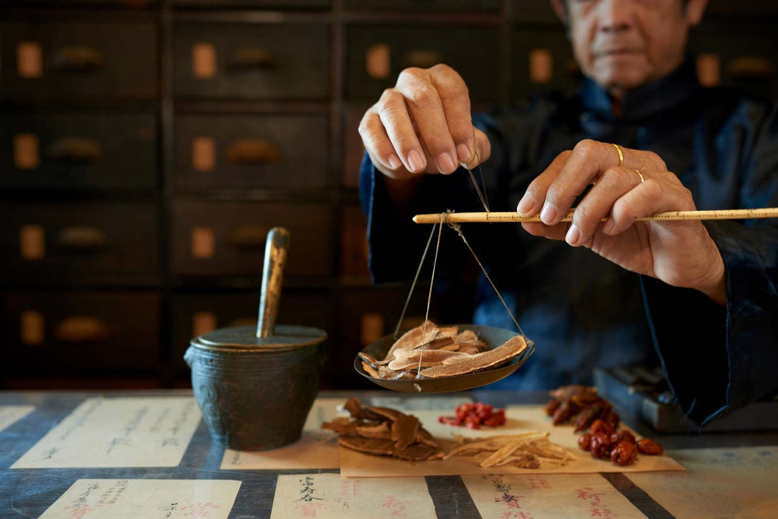 Traditional Chinese Medicine herbs and natural remedies arranged on a wooden surface