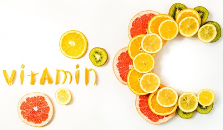 Different forms of vitamin C supplements including capsules and tablets on a clean background
