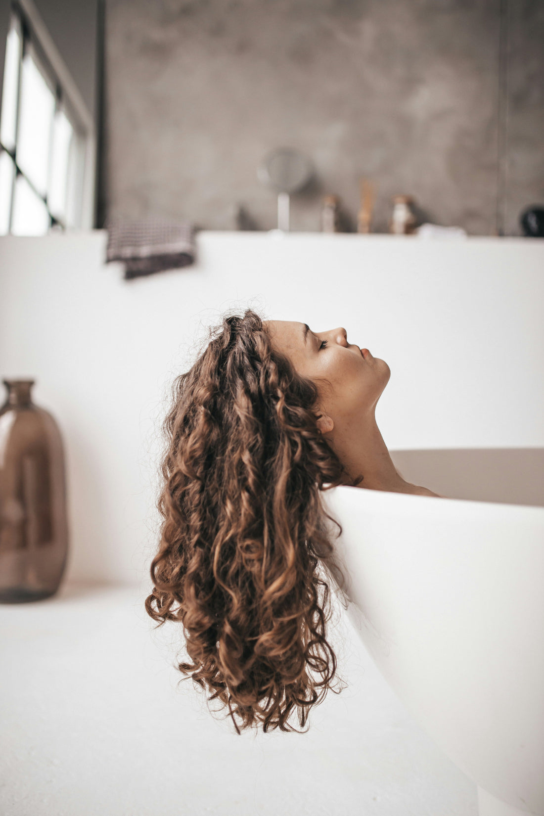 Woman and man examining their hair, representing hair loss concerns in both females and males