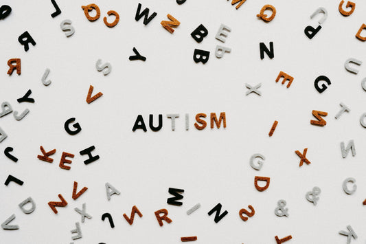 Illustration representing Autism Spectrum Disorder awareness with colourful puzzle pieces and supportive hands