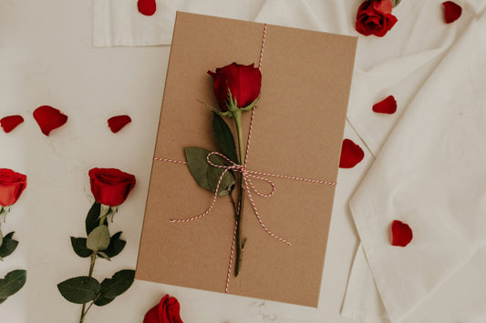 Valentine's Day themed flatlay with spices, candles, and romantic treats for couples and singles