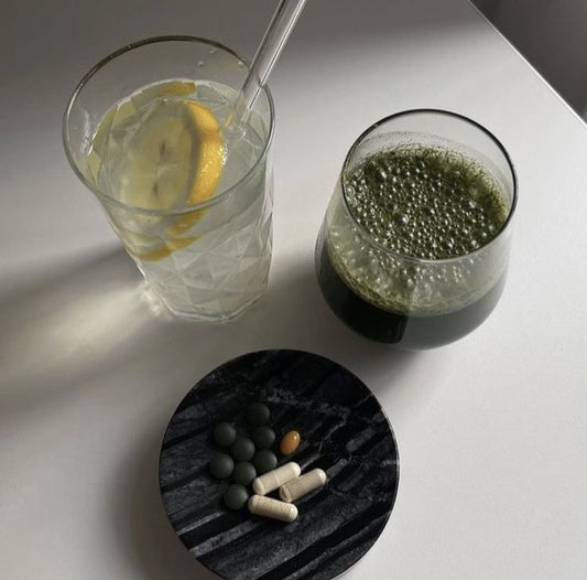 Arrangement of autumn fruits, vegetables, and vitamin supplements on a wooden table