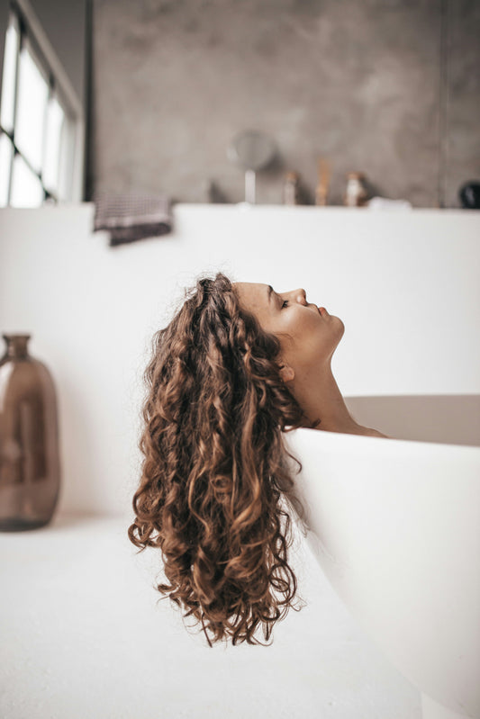 Woman and man examining their hair, representing hair loss concerns in both females and males